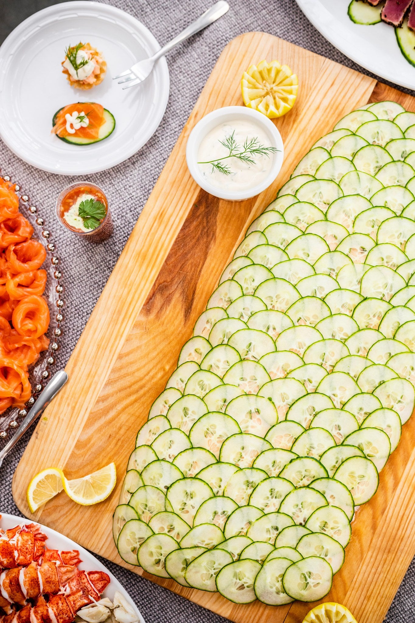 Platter of poached salmon with cucumber and dill sauce